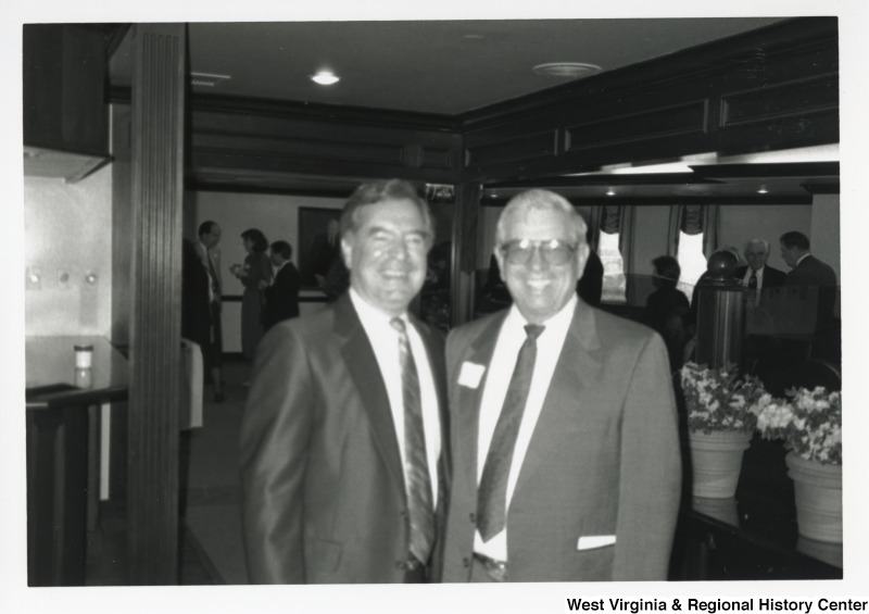 On the left, Representative Nick J. Rahall (D-W.Va.) smiles for a photograph with an unidentified man.
