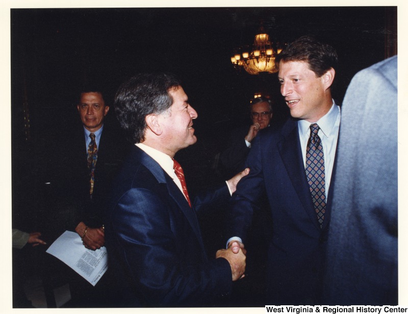 On the left, Representative Nick J. Rahall (D-W.Va.) shakes hands with Al Gore.