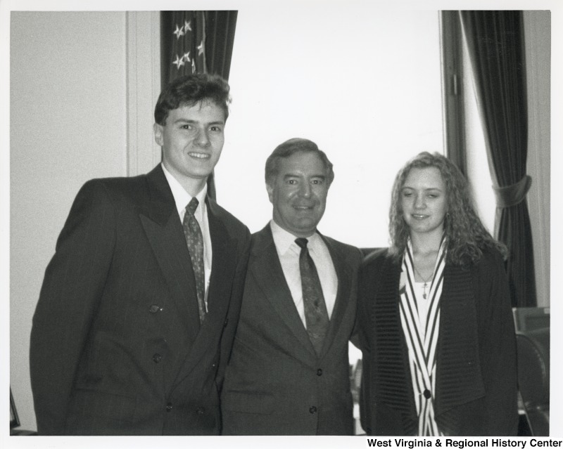 In the middle, Representative Nick J. Rahall (D-W.Va.) smiles for a photograph with two unidentified students.