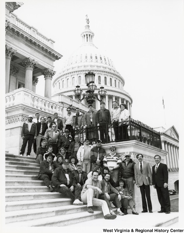 On the far right, Representative Nick J. Rahall (D-W.Va.) stands for a photograph with Davis & Elkins College's Veterans Upward Bound Program in front of the capitol building.