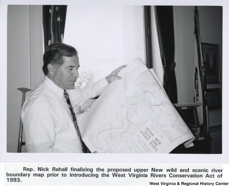 Representative Nick J. Rahall (D-W.Va.) looks at a map. The caption under the photograph reads "Rep. Nick Rahall finalizing the proposed upper New wild and scenic river boundary map prior to introducing the West Virginia Rivers Conservation Act of 1993."