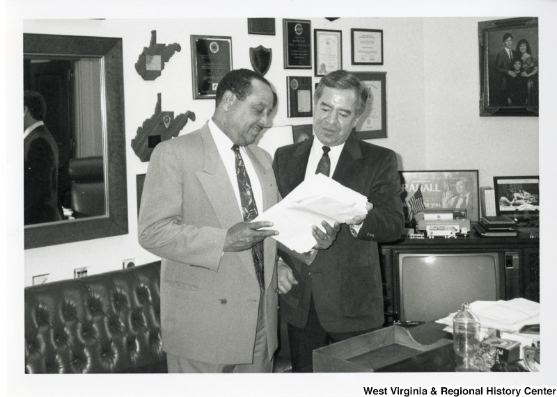 Congressman Nick Rahall (D-WV) shows Acting Secretary of the Army John Shannon the letters he received from West Virginians concerned about the proposed downsizing of the United States Army Corps of Engineers Hunting District Office.