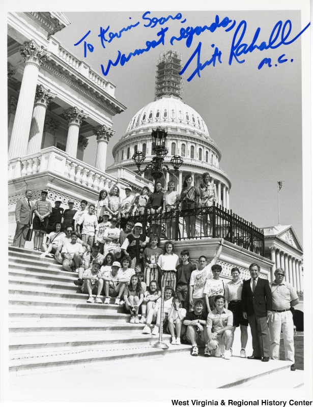 Congressman Nick Rahall (D-WV) with Webster Springs students in front of the U.S. Capitol building. The photo is signed: "To Kevin Sears, Warmest regards, Nick Rahall M.C.