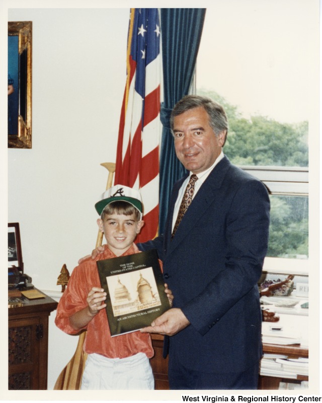 Congressman Rahall in his office holding a book with Ryan Crook of the Save Lebanon Group.