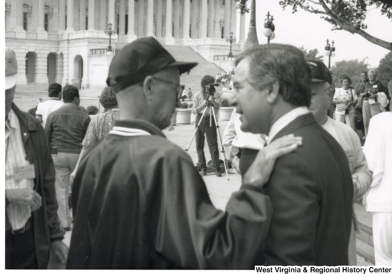 Congressman Nick Rahall (D-WV) speaking with an unidentified man at a Black Lung Association rally at the United States Capitol building.