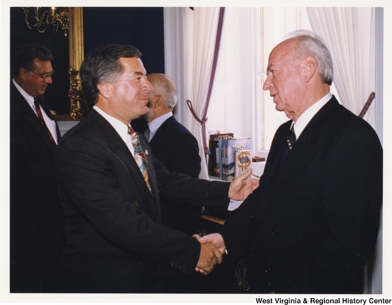 Congressman Nick Rahall (D-WV) shaking hands with an unidentified man.