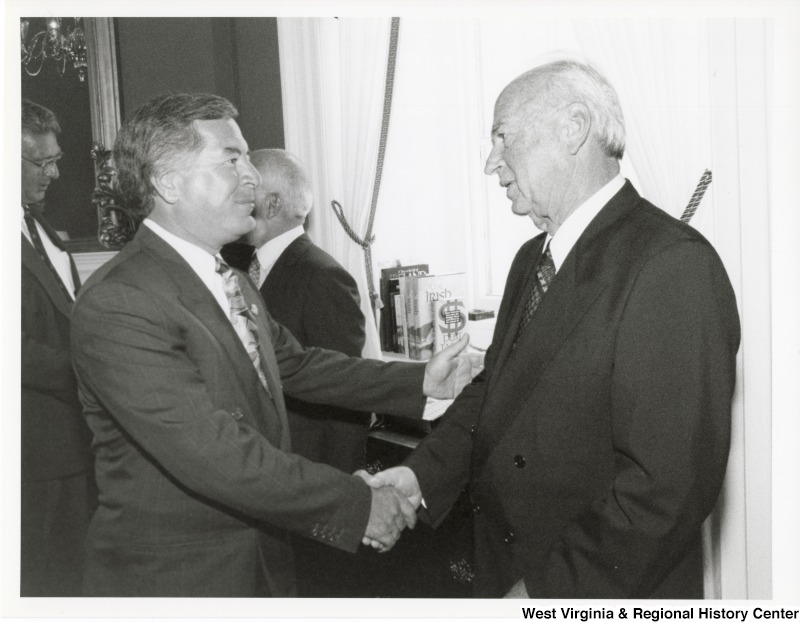 Congressman Nick Rahall (D-WV) shaking hands with an unidentified man.