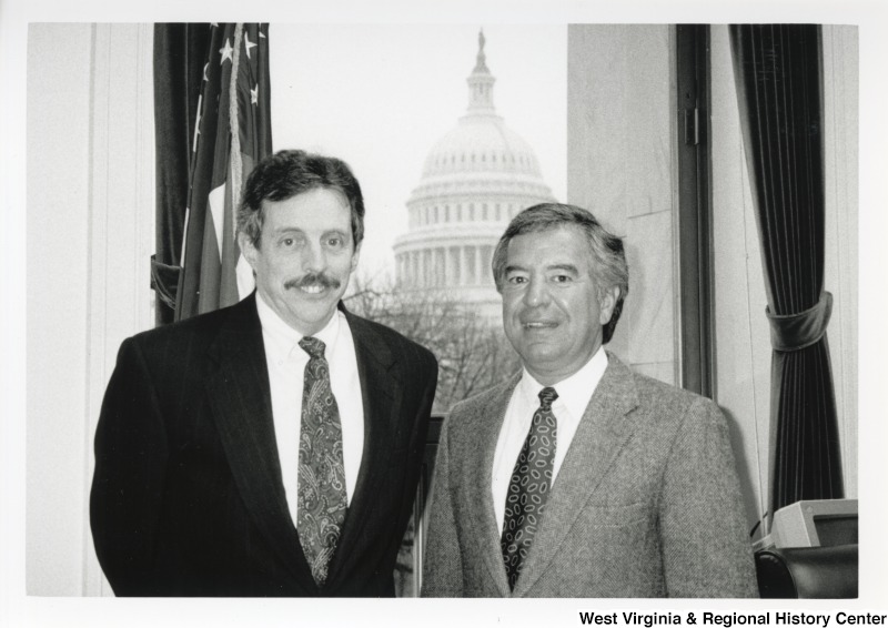 On the right, Representative Nick J. Rahall (D-W.Va.) stands for a photograph with Davitt McAteer in his office with the United States Capitol building in the background.