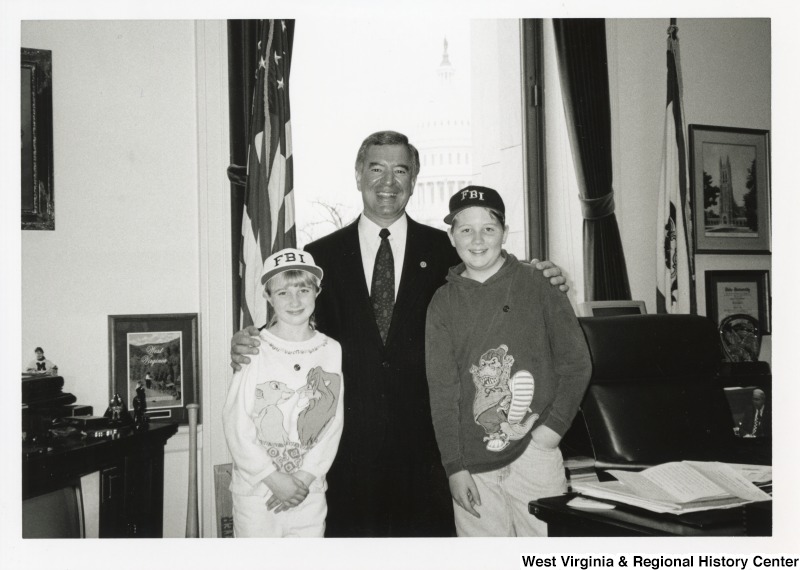 In the center, Representative Nick J. Rahall (D-W.Va.) smiles for a photograph with a young boy and girl, the children of Mayor Jim Leslie of Hinton, West Virginia.