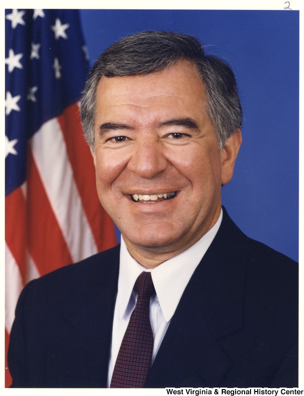 Representative Nick J. Rahall (D-W.Va.) smiles for a portrait in front of an American flag.