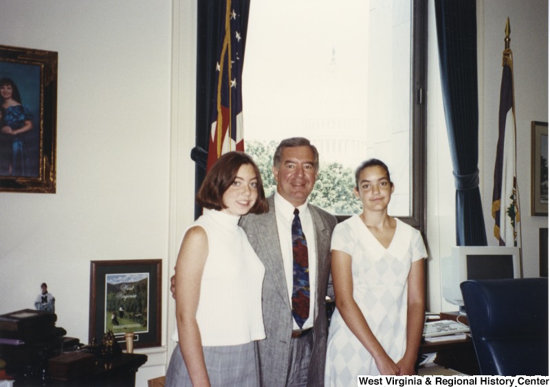 Representative Nick J. Rahall (D-W.Va.) stands between two unidentified young women.