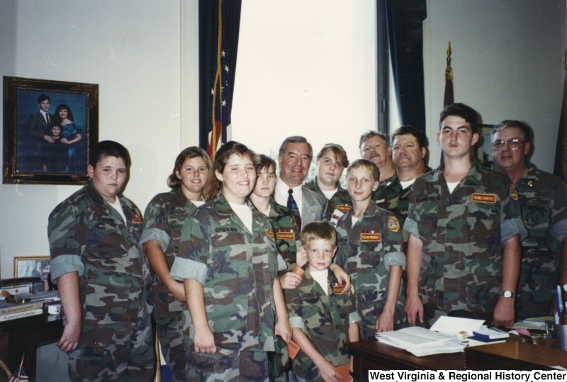 Representative Nick J. Rahall (D-W.Va.) stands for a photograph with an unidentified group of people from the Young Marines of Tug Valley.