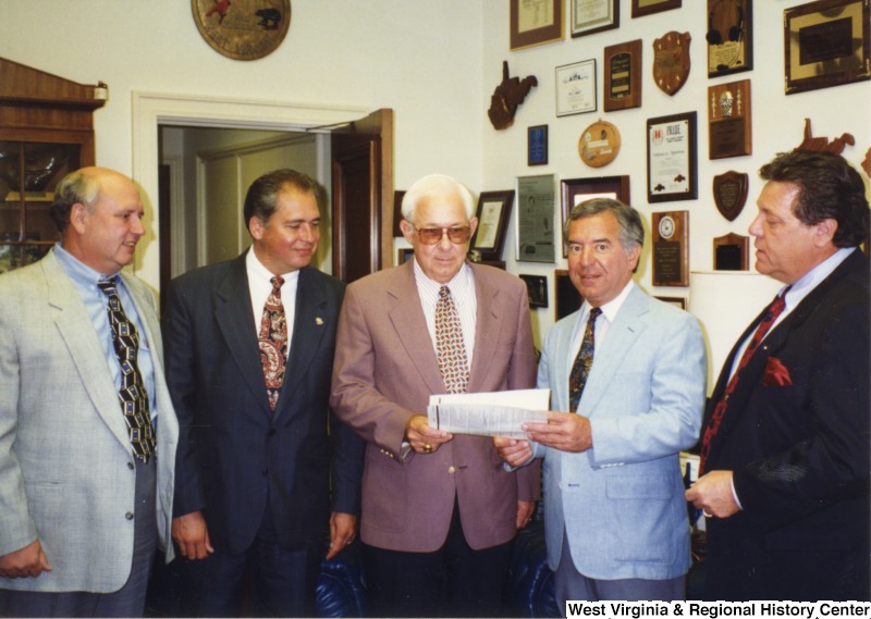 L-R: unidentified man, state Senate president Earl Ray Tomblin (D-W.Va.), unidentified man, Representative Nick J. Rahall (D-W.Va.), unidentified manThese five men stand in a row for a photograph.