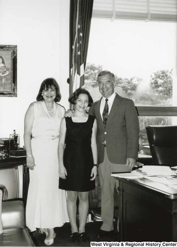 On the right, Representative Nick J. Rahall (D-W.Va.) stands for a photograph in an office with two unidentified women.