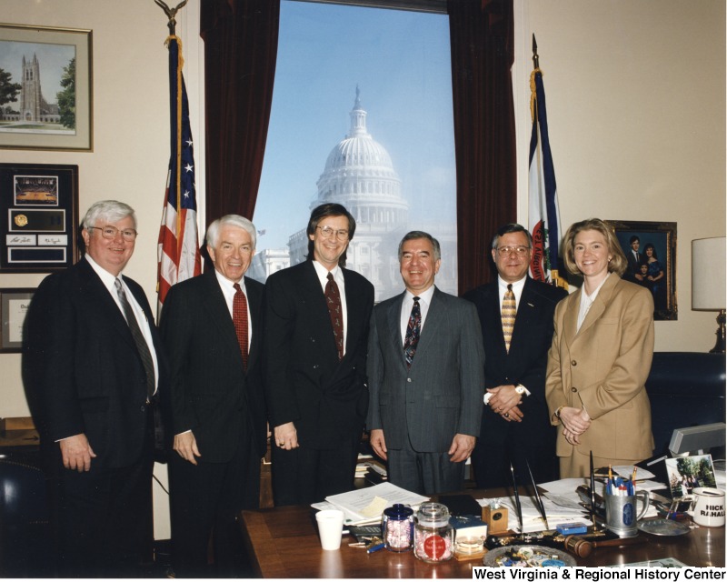 Photograph of Congressman Nick Rahall (D-WV) with a group of unidentified people in his D.C. office.