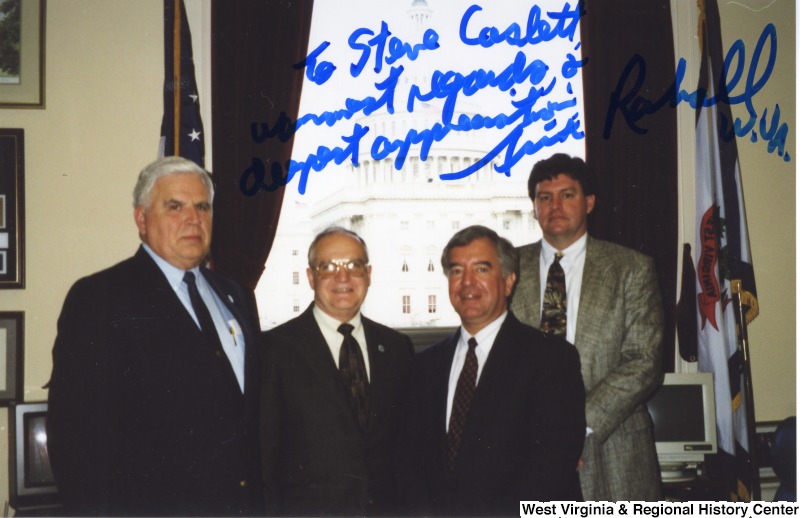 Congressman Nick Rahall (D-WV) with Steve Caslett and two unidentified men in his D.C. office. Photograph is signed: "To Steve Caslett, warmest regards & deepest appreciation, Nick Rahall W.Va. "