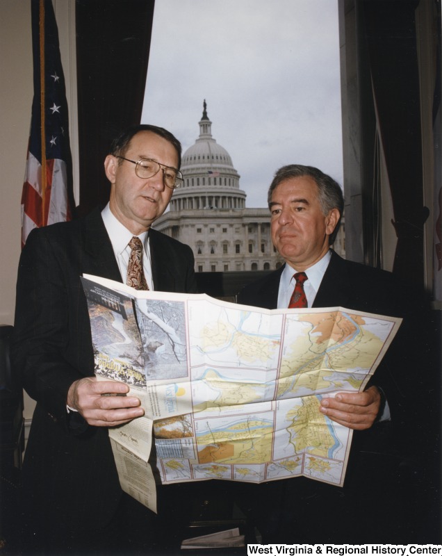 Congressman Nick Rahall (D-WV) looking at a  map with Federal Highway Administration administrator Ken Wykle in his D.C. office.
