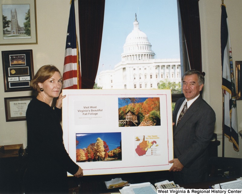 Congressman Nick Rahall (D-WV) and West Virginia University Institute of Technology President Karen LaRoe with a poster about West Virginia's fall foliage in his D.C. office.