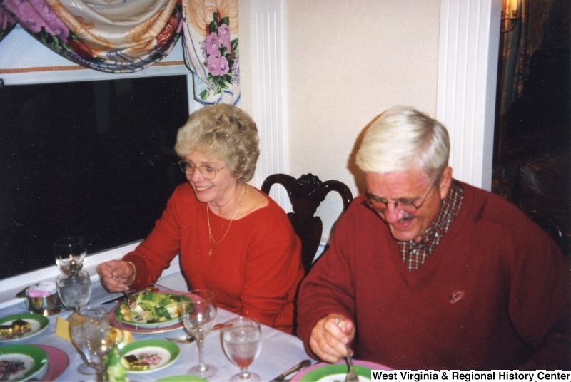 Two unidentified senior citizens eating dinner on a Chessie Seaboard Consolidated (CSX) train.