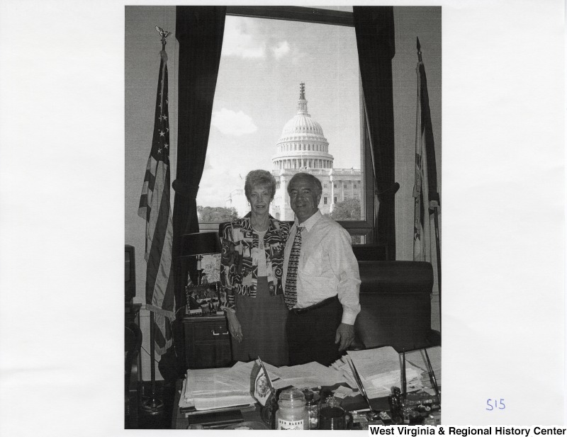On the right, Representative Nick J. Rahall (D-W.Va.) stands for a photograph in his office with an unidentified woman.