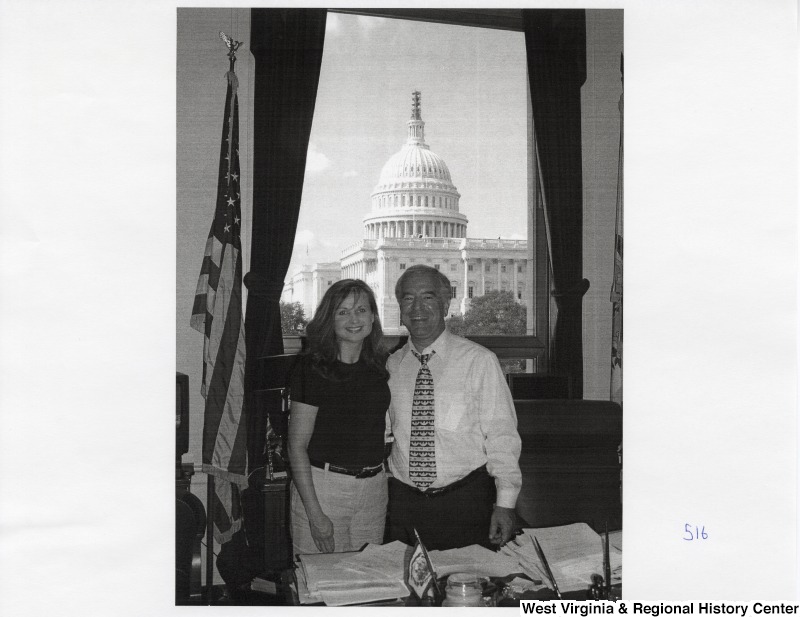 On the right, Representative Nick J. Rahall (D-W.Va.) stands for a photograph in his office with an unidentified woman.