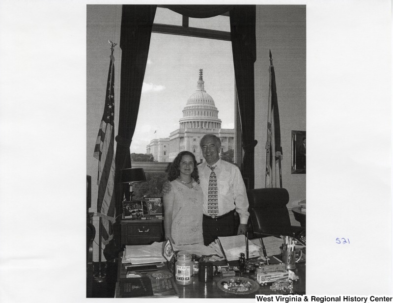 On the right, Representative Nick J. Rahall (D-W.Va.) stands for a photograph in his office with one of his daughters.
