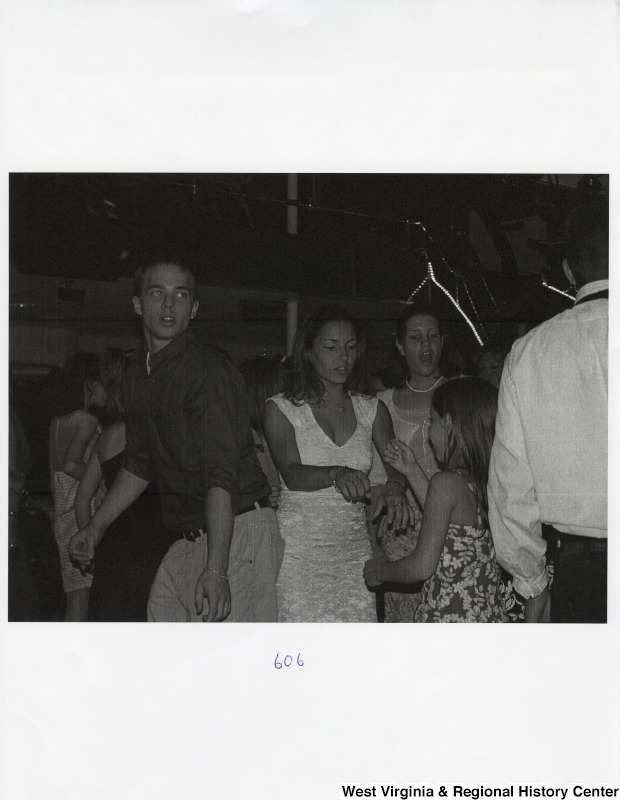 A group of unidentified people dance together at a party.