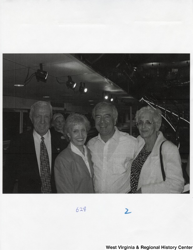Second from the right, Representative Nick J. Rahall (D-W.Va.) stands for a photograph with two unidentified women and an unidentified man at a party.