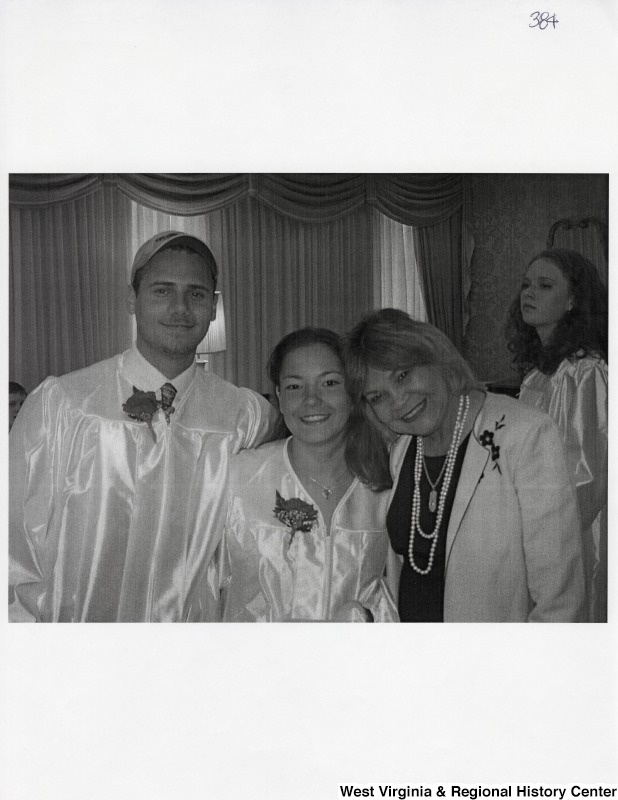 Suzanne Rahall, daughter of Representative Nick J. Rahall (D-W.Va.), in graduation regalia stands between an unidentified young man in a graduation gown and an unidentified woman.