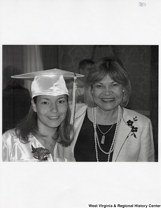 On the left, Suzanne Rahall stands in graduation regalia for a photograph with an unidentified woman.