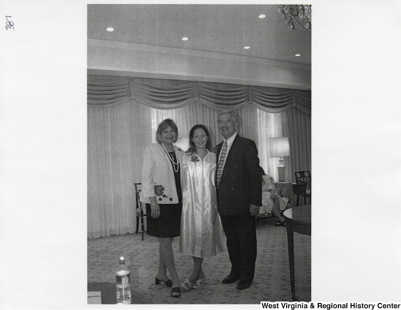 L-R: unidentified woman, Suzanne Rahall, Representative Nick J. Rahall (D-W.Va.)The three stand for a photograph while Suzanne wears a graduation gown.