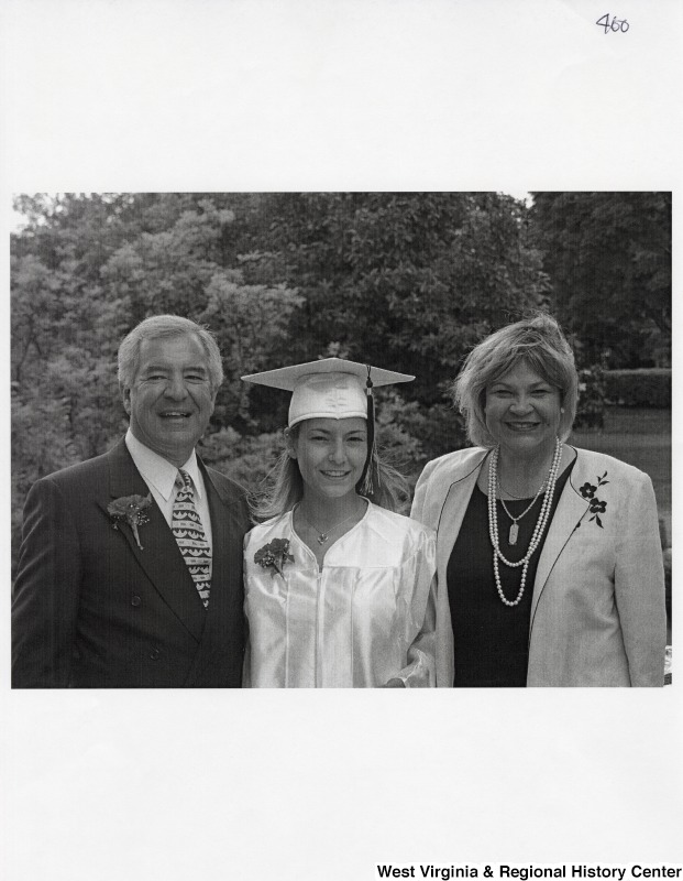 L-R: Representative Nick J. Rahall (D-W.Va.), Suzanne Rahall, unidentified womanThe three stand and smile for a photograph while Suzanne wears graduation regalia.