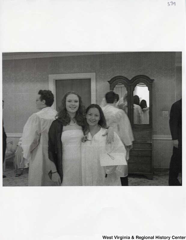 On the right, Suzanne Rahall stands with an unidentified young woman while she wears her graduation gown.