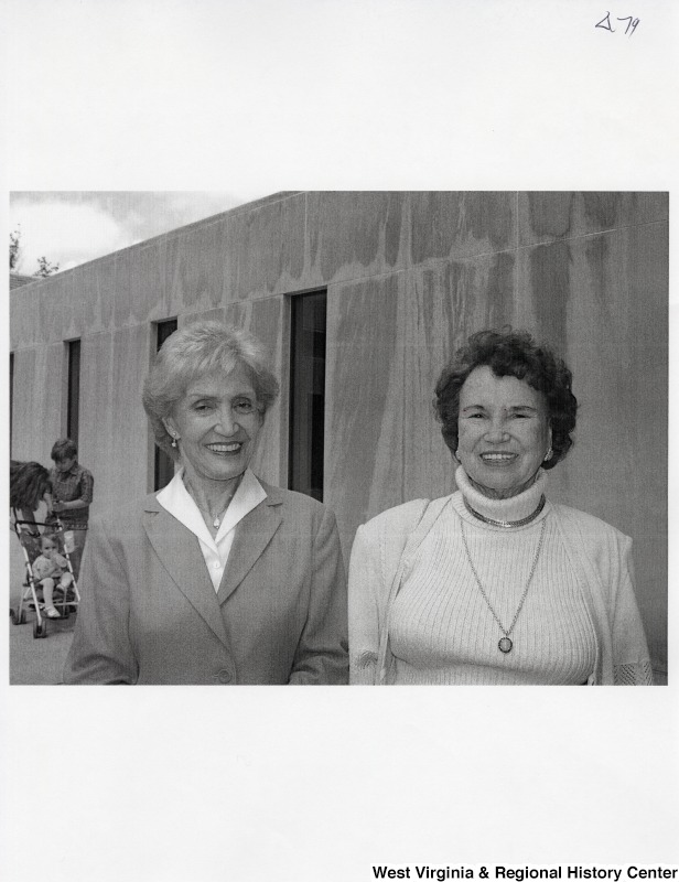 Two unidentified women smile for a photograph.
