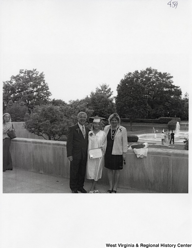 L-R: Representative Nick J. Rahall (D-W.Va.), Suzanne Rahall, unidentified womanThe three stand outside for a photograph while Suzanne wears her graduation regalia.