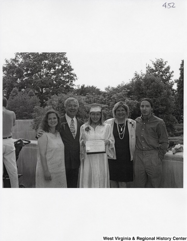 L-R: Rebecca Rahall, Representative Nick J. Rahall (D-W.Va.), Suzanne Rahall, unidentified woman, unidentified manThe five stand for a photograph while Suzanne holds her diploma.