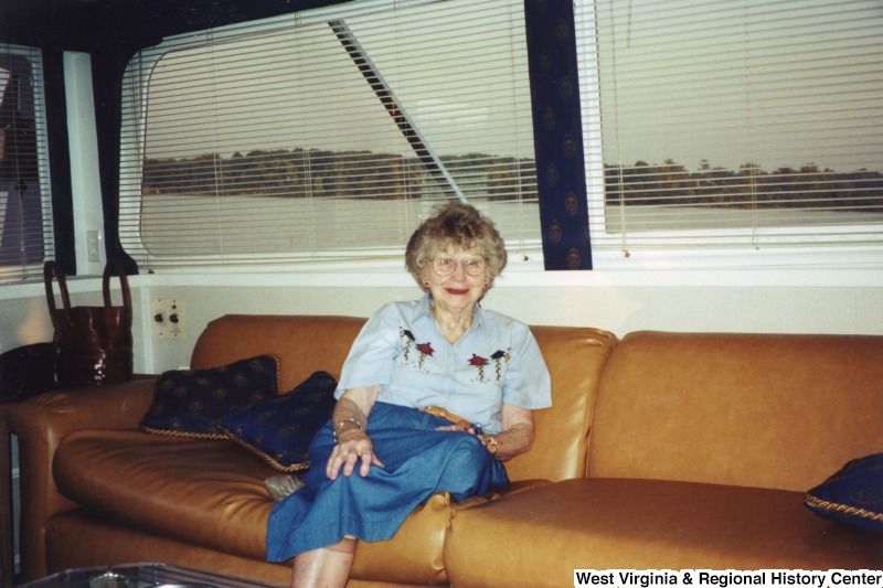 An unidentified older woman sits on a boat.
