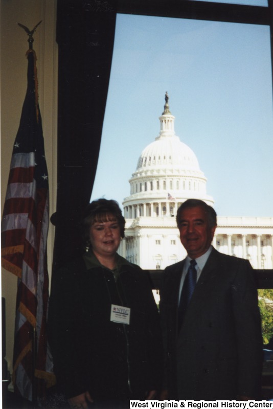 On the right, Representative Nick J. Rahall (D-W.Va.) stands for a photograph with an unidentified woman in his office.