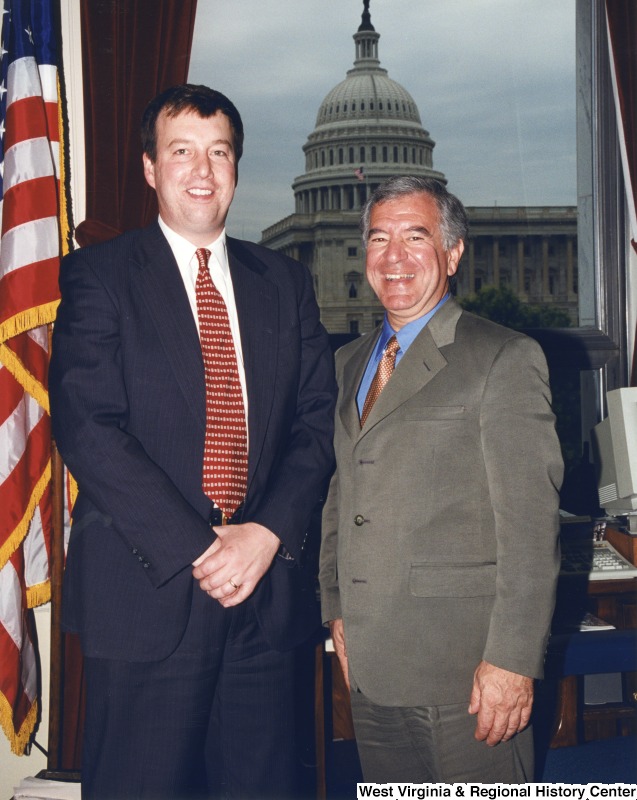 On the right, Representative Nick J. Rahall (D-W.Va.) stands for a photograph with an unidentified man in his office.