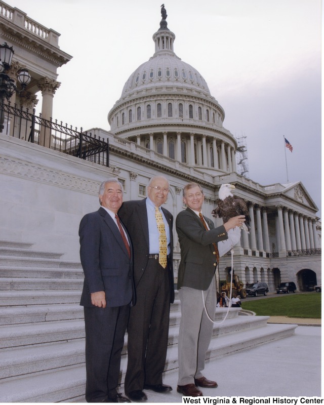 Congressman Nick Rahall (D-WV) at a Public Lands Press Conference with two unidentified men. One of the men is holding a bald eagle.