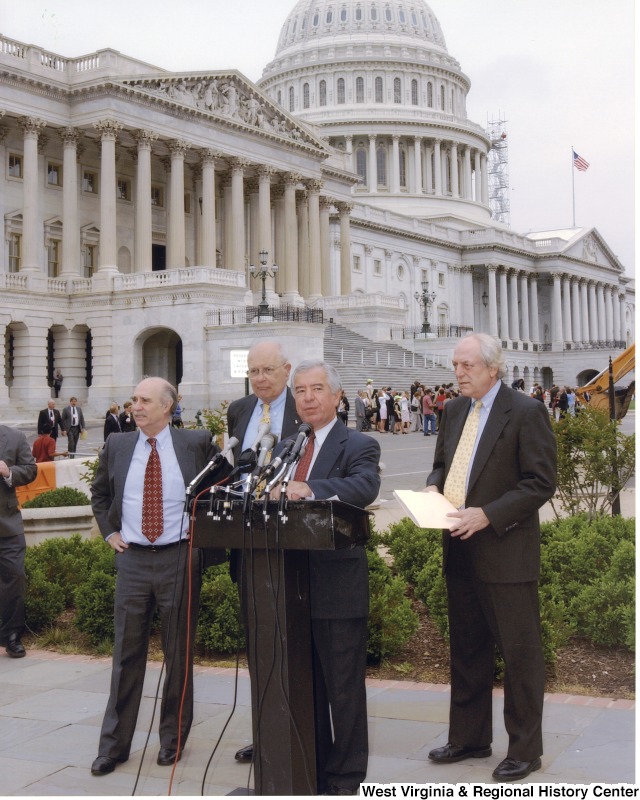 Congressman Nick Rahall speaking at a Public Lands Press Conference. Three unidentified men are in the background.