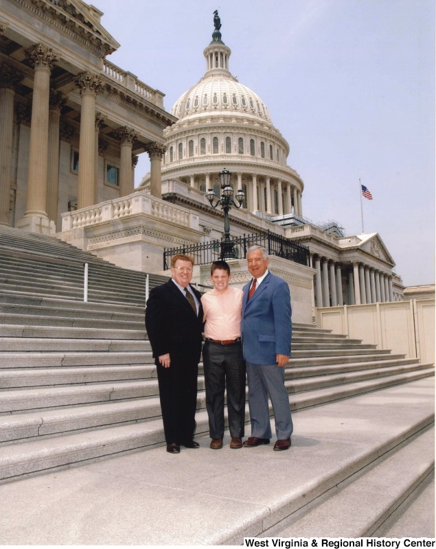 Congressman Nick Rahall (D-WV) with two unidentified people in front of the United States Capitol building.