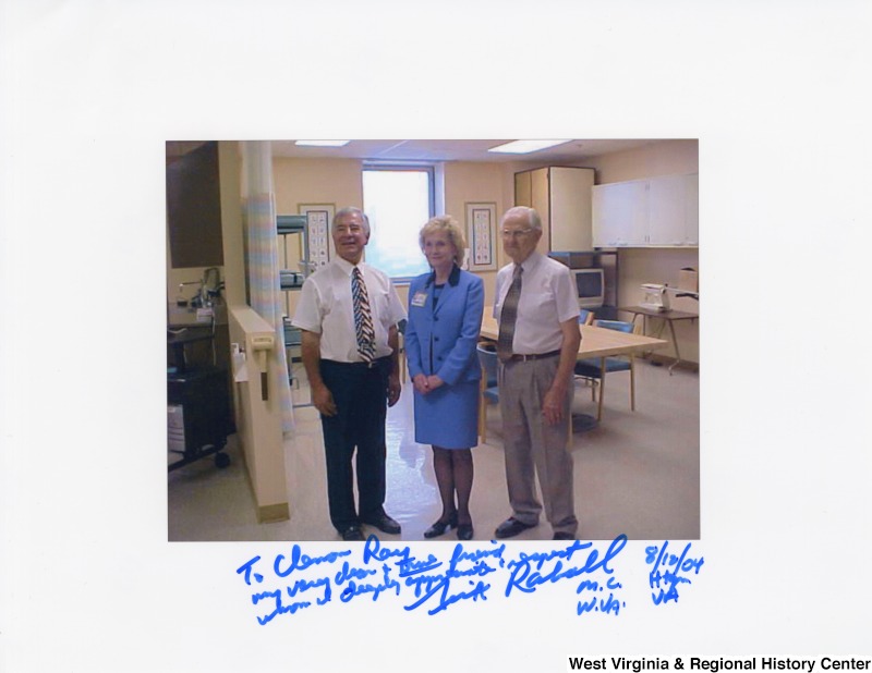 Congressman Rahall (D-WV) with Mr. Ray and an unidentified woman at Hershel "Woody" Williams Veteran Affairs Medical Center. Photograph is signed: "To Clarence? Ray, My very dearest friend whom I deeply appreciate and respect, Nick Rahall M.C. W.Va. 8/12/04 Huntington VA. "