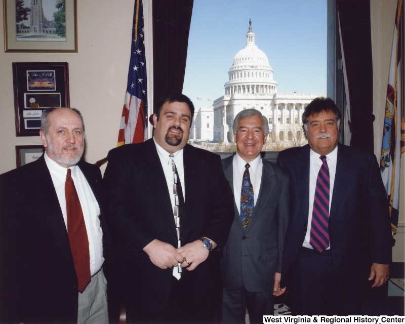 Congressman Nick Rahall (D-WV) with three unidentified men in his D.C. office.
