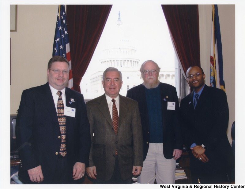 Congressman Nick Rahall (D-WV) with three unidentified men from the American Cancer Society in his D.C. office.