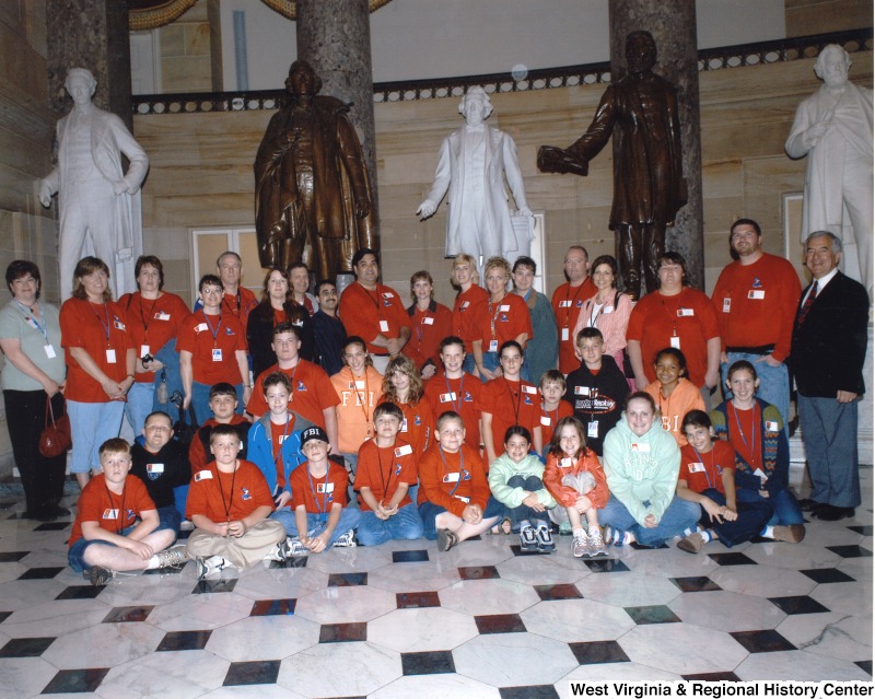 Congressman Nick Rahall with an unidentified group of people from Soaring Eagle Ministries International, Inc. inside the statue hall of the United States Capitol building.