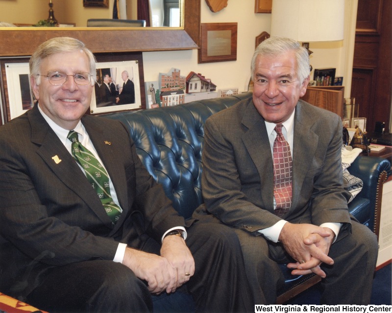 Congressman Nick Rahall (D-WV) sitting on a couch with an unidentified man in his D.C. office.