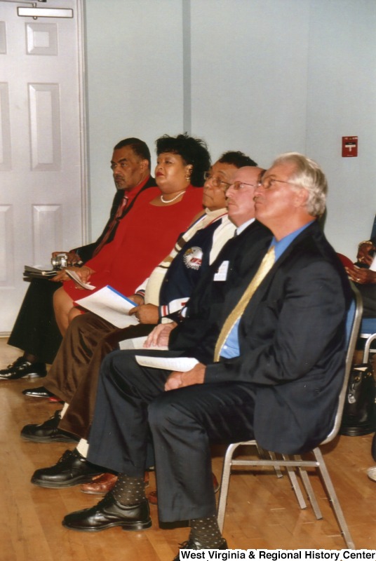 An unidentified group of people sitting at an event in Bramwell, West Virginia.