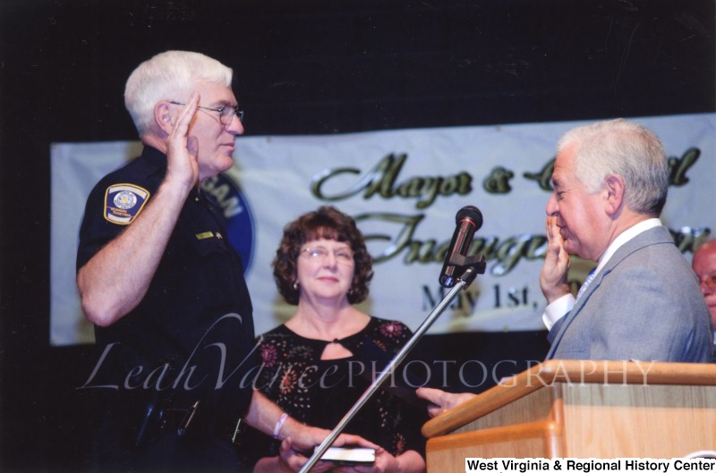 Congressman Nick Rahall (D-WV) swearing in an officer at the City of Logan Mayor and Council Inauguration.