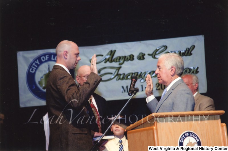 Congressman Nick Rahall (D-WV) swearing in an unidentified man at the City of Logan Mayor and Council Inauguration.